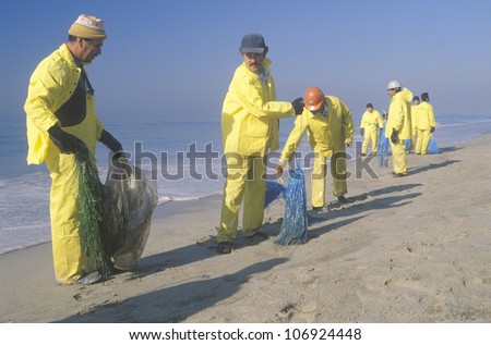 CIRCA 1990 - Teams of environmental workers organizing cleanup efforts of the oils spill in Huntington Beach, California