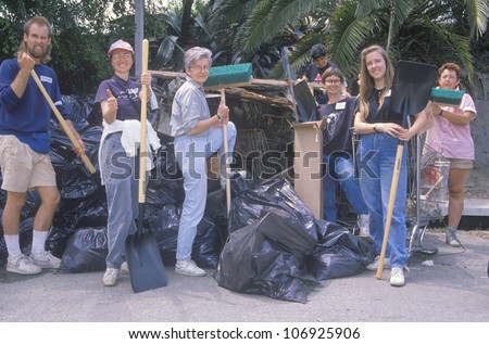 CIRCA 1990 - A group of community people clean up the river on Earth Day
