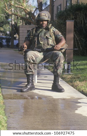 A National Guard member in riot gear outside a Los Angeles building after the earthquake of January 17, 1994