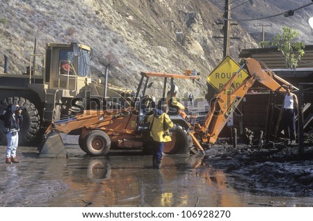 CIRCA 1994 - A wheel loader clearing the road after a major mudslide on the Pacific Coast Highway, near Malibu, CA