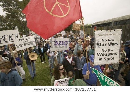 Protesters march with peace flag against President George W. Bush and the Iraq war at an anti-Iraq War protest march in Santa Barbara, California on March 17, 2007