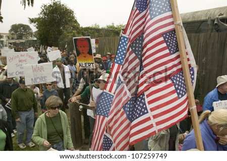 Protesters march with US Flag against President George W. Bush and the Iraq war at an anti-Iraq War protest march in Santa Barbara, California on March 17, 2007