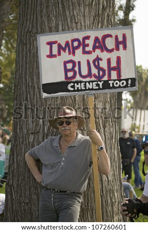 A protester holds a sign reading \