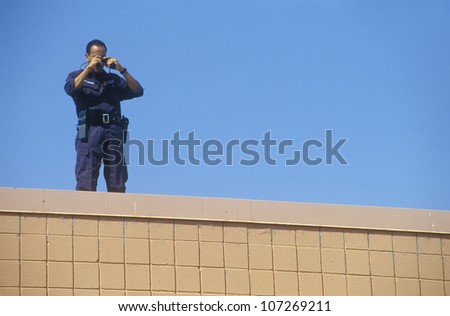 Secret Service agent on rooftop security duty during Clinton/Gore 1992 campaign