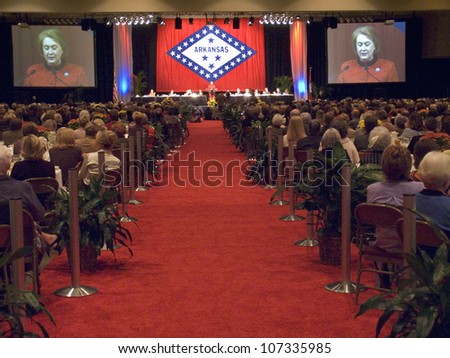 Janet McCain Huckabee speaks at the podium during a luncheon honoring the First Ladies of the state November 17, 2004 in the build-up to the opening of the William J. Clinton Presidential Library.