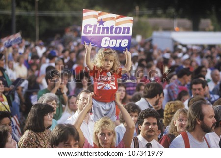 Little girl with Clinton/Gore sign stands out in the crowd during the Clinton/Gore 1992 Buscapade campaign tour in Tyler, Texas
