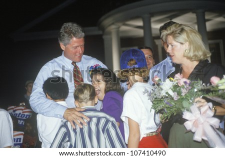 Governor Bill Clinton embraces a group of children at Tyler Junior College on the Clinton/Gore 1992 Buscapade campaign tour in Tyler, Texas