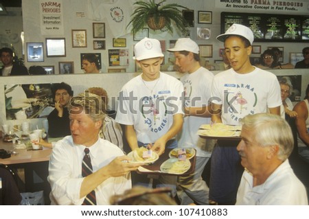 Governor Bill Clinton dines with the owner of Parma Peiroges Restaurant during the Clinton/Gore 1992 Buscapade campaign tour in Parma, Ohio