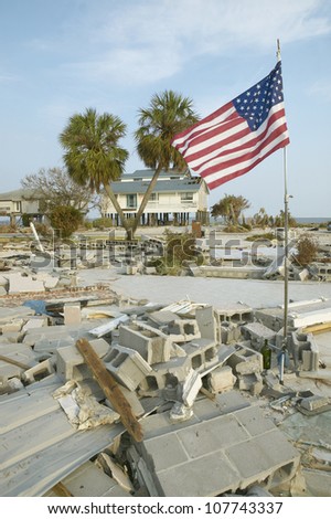 CIRCA 2004 - American Flag and destroyed house after Hurricane Ivan hits in Pensacola Florida