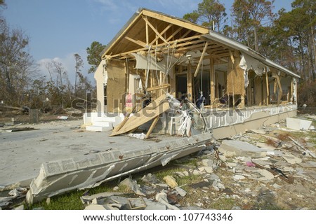 CIRCA 2004 - Debris in front of house heavily hit by Hurricane Ivan in Pensacola Florida