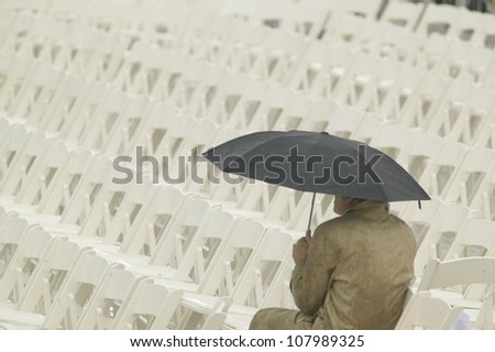 A lone person with umbrella awaiting the opening ceremonies of the Clinton Presidential Library,  November 18, 2004 in Little Rock, AK