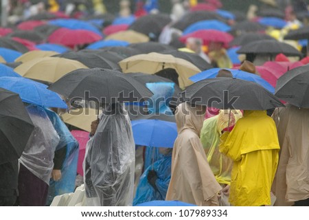 Guests hold umbrellas in the rain during the official opening ceremony of the Clinton Presidential Library November 18, 2004 in Little Rock, AK