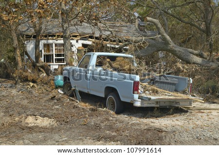 Old pickup truck and debris in front of house heavily hit by Hurricane Ivan in Pensacola Florida