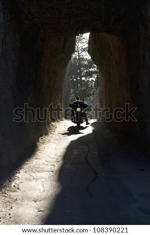 Motorcyclist driving through tunnel on Needles Highway, Black Hills, South Dakota