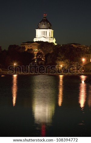 Water with reflection of South Dakota State Capitol and complex at night, Pierre, South Dakota