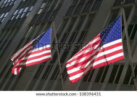Two American flags in front of New York Stock Exchange on Wall Street, New York