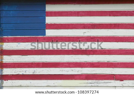 American flag painted on side of rustic dwelling along Highway 22 in Central Georgia