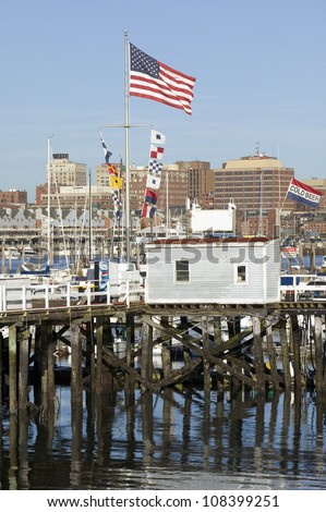 Large American flag flies in Portland Harbor with south Portland skyline, Portland, Maine