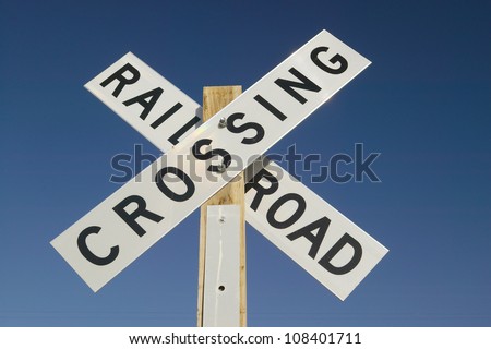 Railroad crossing sign and intersection in Mojave Desert of Southern California