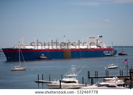 BOSTON - JUNE 08: Ocean freighter named Matthew enters Boston Harbor with tug boats on June 08. 2012, Boston, MA.