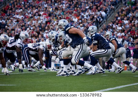 BOSTON - OCTOBER 16: Quarterback Tony Romo, No 9 of Dallas Cowboys takes hike at Gillette Stadium, New England Patriots vs. Dallas Cowboys on October 16, 2011 in Foxborough, Boston, MA