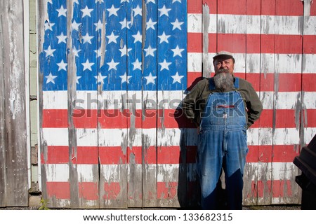 AUGUSTA - JUNE 10: Elderly man poses in front of US flag painted on his shed on June 10, 2012 near Augusta, Maine