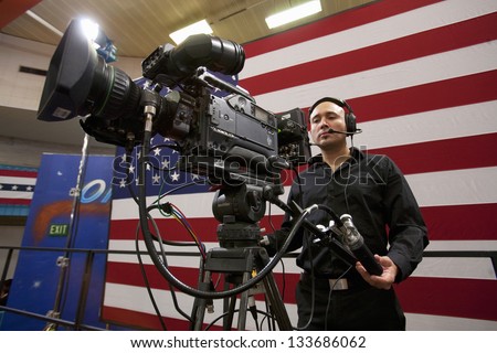 LAS VEGAS - OCTOBER 26: National Press and TV cameraman at an event hosted by First Lady Michelle Obama at Orr Middle School on October 26, 2012 in Las Vegas, Nevada