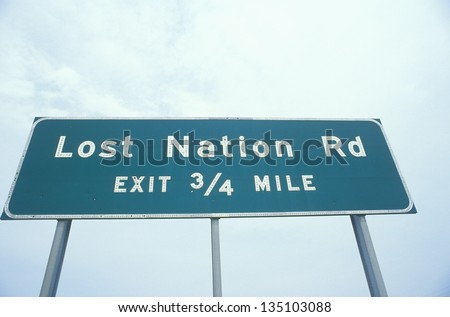 Lost Nation Rd - Exit 3/4 mile sign against the sky