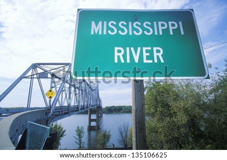Mississippi River sign in front of a truss bridge