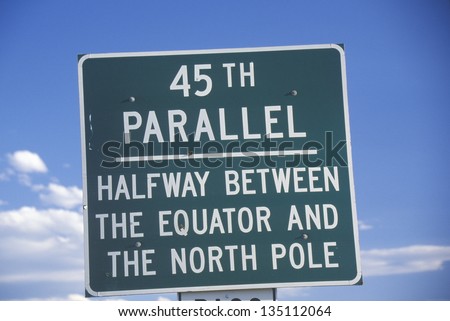 \'45th Parallel - Halfway Between The Equator And The North Pole\' sign against the sky