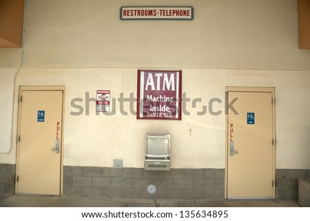 Signs directing people to ATM machine and restrooms, north of Tucson, AZ