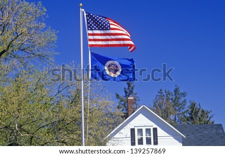 State Flag of Minnesota with US flag on a pole