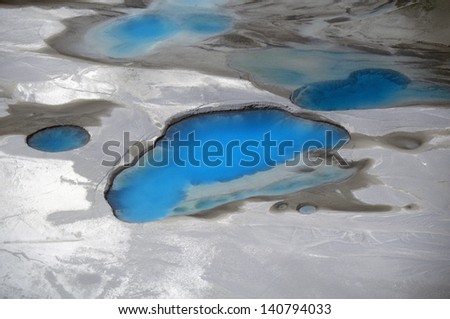 Aerial view of silt and turquoise water in an Alaska glacier, Alaska