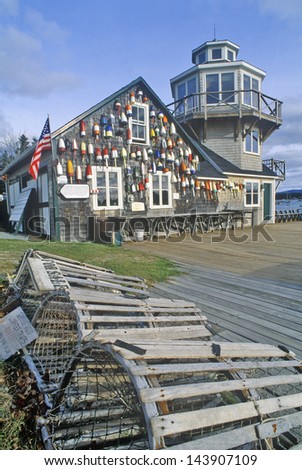 Floats from fishing nets hang on the side of a lighthouse in Stonington, Mount Desert Island, Maine
