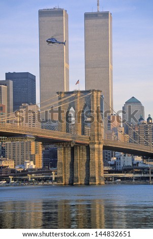 World Trade Towers and Brooklyn Bridge with TV helicopter flying by, New York City, NY