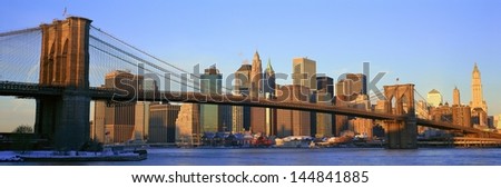 Brooklyn Bridge and East River at sunrise with New York City skyline, NY