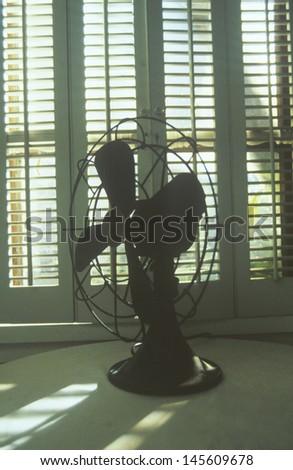 Antique electric fan in front of a window
