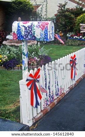 Patriotic decorations on residential mailbox and white picket fence, Cayucos, CA