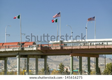 Border of Mexico and the United States, with flags and walking bridge connecting El Paso Texas to Juarez, Mexico