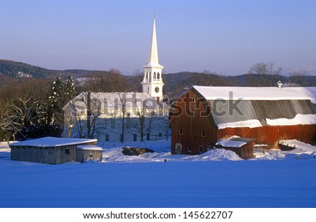 Church and barn in Peacham, VT in snow in winter