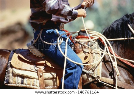 GALLUP, NEW MEXICO - CIRCA 1980\'s: Cowboy riding horse with rope, Gallup, New Mexico