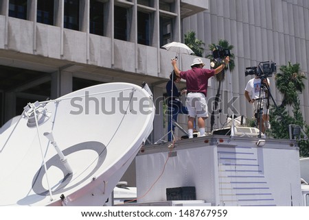 DOWNTOWN LOS ANGELES, CA - CIRCA 1995: News crew setting up coverage of O.J. Simpson`s trial circa 1995 in Los Angeles, CA.