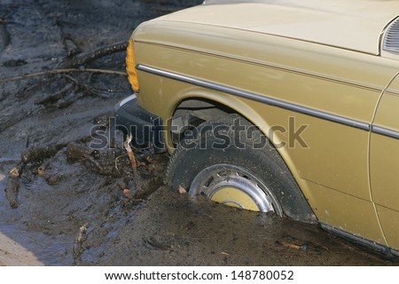 LOS ANGELES, CA - CIRCA 1990\'s: Car stuck in deep mud in Los Angeles, CA