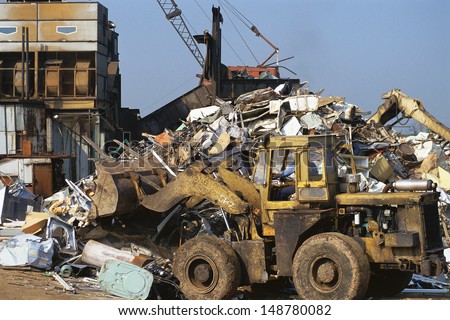 JUNK YARD, ATLANTA GEORGIA - CIRCA 1990\'s: Excavator in urban dump yard in Atlanta, GA