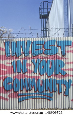 LOS ANGELES, CA  - CIRCA 1990\'s: A sign that reads `invest in your community` in Los Angeles, CA