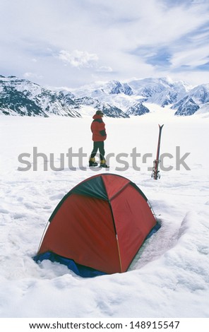 WRANGELL MOUNTAINS, WRANGELL, ALASKA  - CIRCA 2001: Tent and mountain climber in Wrangell Mountains in St. Elias National Park and preserve, Alaska