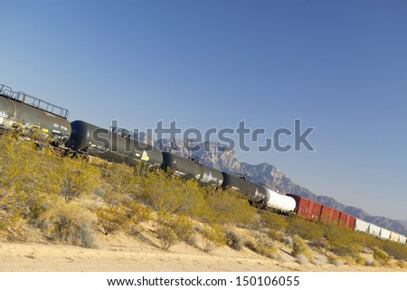 MOJAVE DESERT, CA - JULY 29: Freight train travels through desert and mountainous areas of Mojave Desert on July 29, 2004 in Southern California