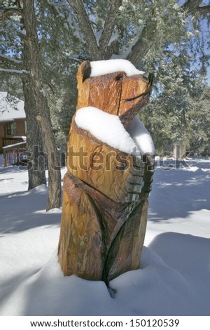 KERN COUNTY, SOUTHERN CALIFORNIA - CIRCA 2006: Snow on wooden Bear in Pine Mountain Club, Kern County, Southern California