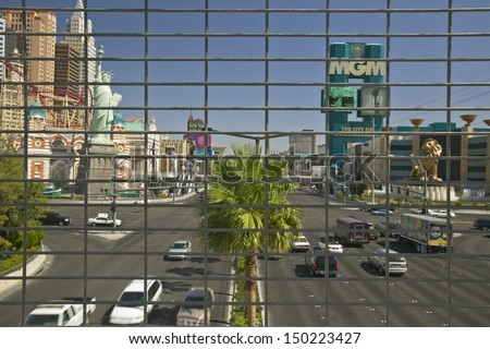 LAS VEGAS, NEVADA - CIRCA 2004: Las Vegas Blvd. Strip and traffic seen through fence in Las Vegas, NV