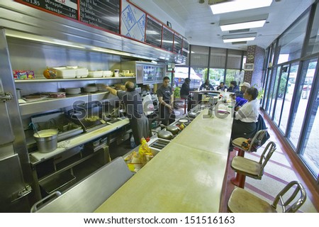 WASHINGTON DC - CIRCA 1980\'s: People eating breakfast at diner counter at old Waffle Shop in Washington DC